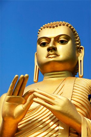 The giant golden Buddha statue sitting on the roof of the Golden Temple in Dambulla, Sri Lanka. Built in 2001 it is said to be the largest of its kind in the world. Stock Photo - Budget Royalty-Free & Subscription, Code: 400-04853828