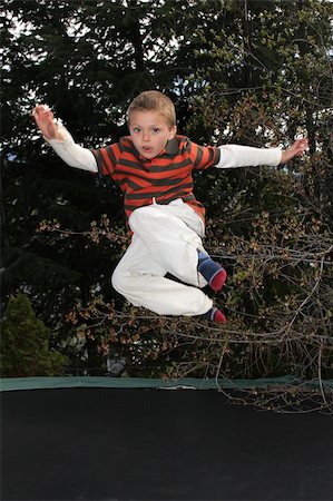 Blond boy jumping on his trampline in the garden Stock Photo - Budget Royalty-Free & Subscription, Code: 400-04864506