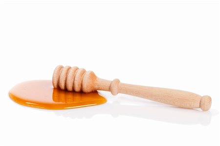 dry honey dipper in a puddle of honey on white background Stock Photo - Budget Royalty-Free & Subscription, Code: 400-04865448