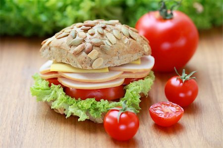 simsearch:400-04416282,k - Closeup of a fresh bun with turkey, cheese and tomatoes Stock Photo - Budget Royalty-Free & Subscription, Code: 400-04865849