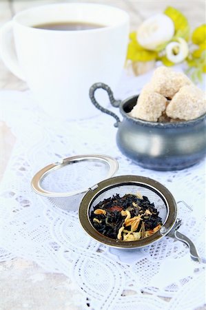 tea strainer with a fragrant black tea and cups in the background Stock Photo - Budget Royalty-Free & Subscription, Code: 400-04865876