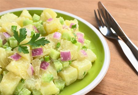 simsearch:400-04855321,k - Potato salad with green and red onions and cucumber with a mayonnaise-cream dressing garnished with a parsley leaf (Selective Focus, Focus on the front of the salad) Stock Photo - Budget Royalty-Free & Subscription, Code: 400-04866017