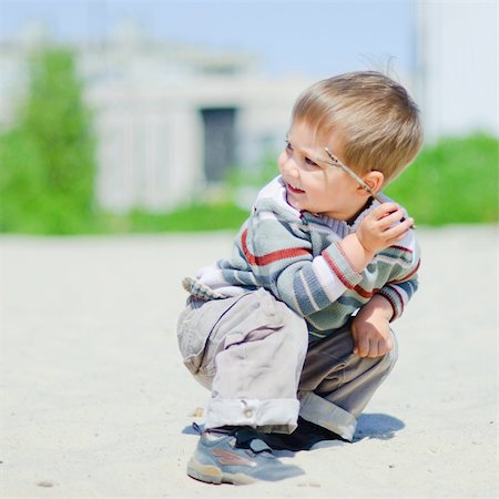The cute boy plaing on a sand Stock Photo - Budget Royalty-Free & Subscription, Code: 400-04866358