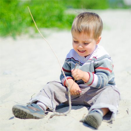 The cute boy plaing on a sand Stock Photo - Budget Royalty-Free & Subscription, Code: 400-04866360