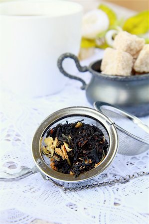 tea strainer with a fragrant black tea and cups in the background Stock Photo - Budget Royalty-Free & Subscription, Code: 400-04866566