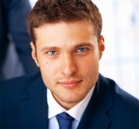 shyshka (artist) - Closeup portrait of smiling young businessman working at the office. Photographie de stock - Aubaine LD & Abonnement, Code: 400-04866734