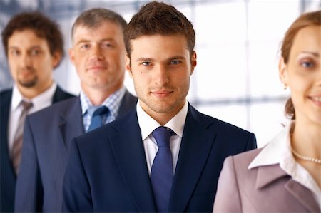 shyshka (artist) - Young serious businessman standing in the row with his colleagues. Photographie de stock - Aubaine LD & Abonnement, Code: 400-04866735