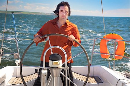 sailor and yacht - Young  skipper driving sailboat / Captain of the yacht Stock Photo - Budget Royalty-Free & Subscription, Code: 400-04866921