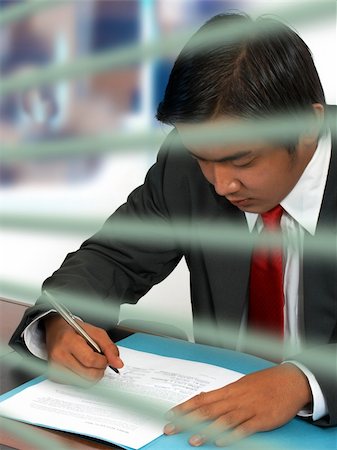 simsearch:400-04782141,k - Businessman reading and signing a document Stock Photo - Budget Royalty-Free & Subscription, Code: 400-04867074