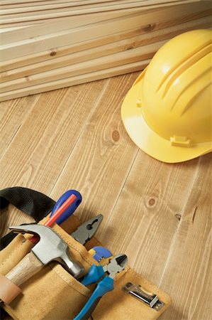 Construction background. Yellow helmet and tool belt on wooden floor. Foto de stock - Super Valor sin royalties y Suscripción, Código: 400-04867295