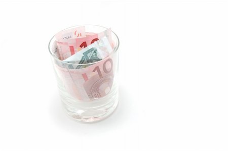 Some euro banknotes in a tumbler isolated on white background Stock Photo - Budget Royalty-Free & Subscription, Code: 400-04867469