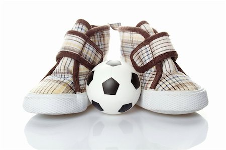 sunny_baby (artist) - Children's shoes and a small soccer ball isolated on white background Foto de stock - Royalty-Free Super Valor e Assinatura, Número: 400-04867614