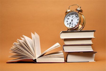 simsearch:700-05974049,k - Alarm clock standing on stack of books near open book Stock Photo - Budget Royalty-Free & Subscription, Code: 400-04867658