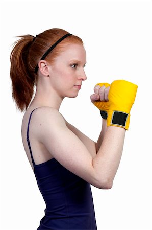 A beautiful young woman wearing a pair of boxing gloves Stock Photo - Budget Royalty-Free & Subscription, Code: 400-04869295