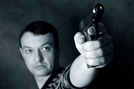 simsearch:400-04816325,k - The man with a pistol on a background Stock Photo - Budget Royalty-Free & Subscription, Code: 400-04869770