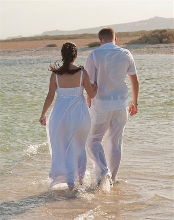 dress wading water - Young newly married couple walking together on a tropical beach Stock Photo - Budget Royalty-Free & Subscription, Code: 400-04860221