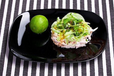 side dish with chicken - Vitamin salad with lime in the black dish Stock Photo - Budget Royalty-Free & Subscription, Code: 400-04860437