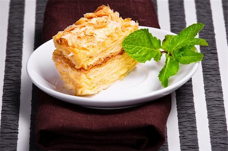 Napoleon cake with fresh mint on white plate Stock Photo - Budget Royalty-Free & Subscription, Code: 400-04860438