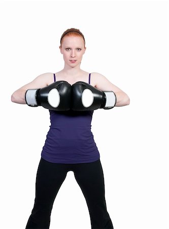 A beautiful young woman wearing a pair of boxing gloves Stock Photo - Budget Royalty-Free & Subscription, Code: 400-04863197