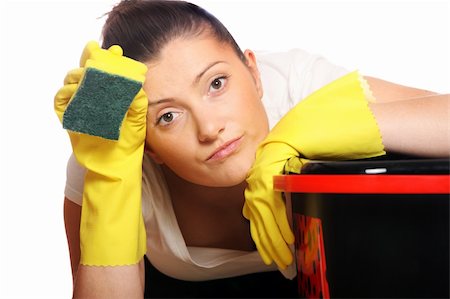 exhausted housewife - A picture of a young tired housewife cleaning over light background Stock Photo - Budget Royalty-Free & Subscription, Code: 400-04863363