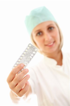 A smiling young nurse holding a package of contraceptive pills Photographie de stock - Aubaine LD & Abonnement, Code: 400-04863411