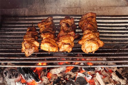 flame grilled chicken photography - four roasted tasty meat on garden grill Stock Photo - Budget Royalty-Free & Subscription, Code: 400-04863814