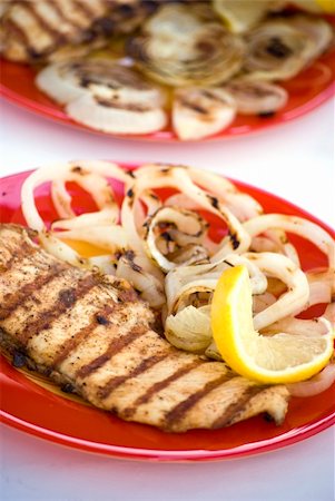 Grilled chicken breasts with onion and lemon in a plate Stock Photo - Budget Royalty-Free & Subscription, Code: 400-04863892