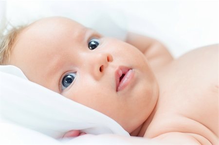 Beautiful cute baby girl is lying in a bed. Stock Photo - Budget Royalty-Free & Subscription, Code: 400-04863902