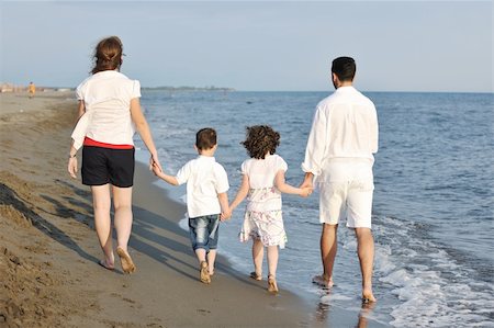 happy young family have fun and live healthy lifestyle on beach Stock Photo - Budget Royalty-Free & Subscription, Code: 400-04874430