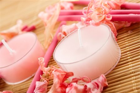 simsearch:400-04715832,k - Spa treatment in bright pink and white palette, petals, candles, and arotatizirovannye sticks on a wooden bamboo rug Fotografie stock - Microstock e Abbonamento, Codice: 400-04874473