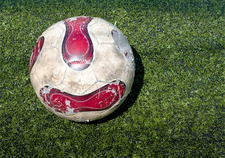 simsearch:400-08372849,k - Red and white Football ball on the grass field Stock Photo - Budget Royalty-Free & Subscription, Code: 400-04874504