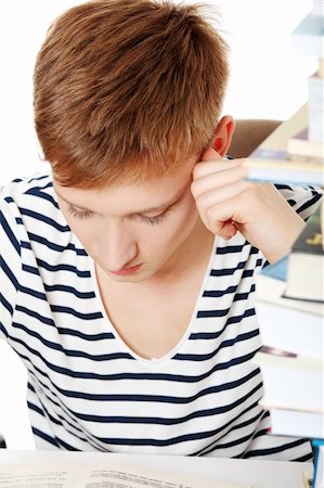 Teen boy learning at the desk, isolated on white Stock Photo - Budget Royalty-Free & Subscription, Code: 400-04874628