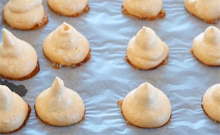 Freshly baked meringue cookies on a baking tray Stock Photo - Budget Royalty-Free & Subscription, Code: 400-04874653