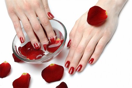 simsearch:400-06061806,k - Beautiful hand with perfect nail red manicure and rose petals. Stock Photo - Budget Royalty-Free & Subscription, Code: 400-04875252