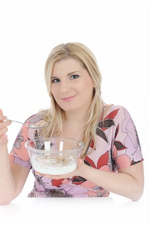 Pretty woman having muesli cereals for breakfast. isolated on white Stock Photo - Budget Royalty-Free & Subscription, Code: 400-04875266