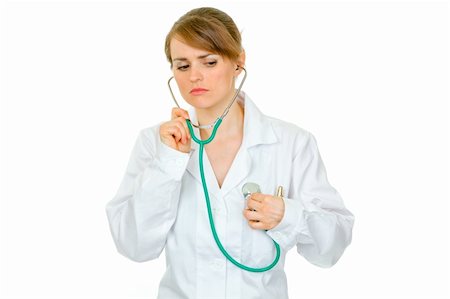 simsearch:400-04351236,k - Concentrated doctor woman listening to her heart with stethoscope isolated on white Photographie de stock - Aubaine LD & Abonnement, Code: 400-04875494