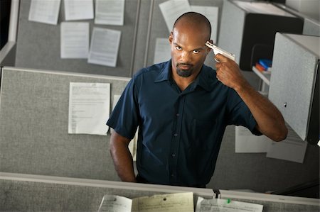 fed up office worker - Native American man gestures to shoot himself in the head using a pistol Stock Photo - Budget Royalty-Free & Subscription, Code: 400-04875760