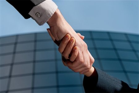 Handshake unrecognizable business man and woman on modern building background Stock Photo - Budget Royalty-Free & Subscription, Code: 400-04876180