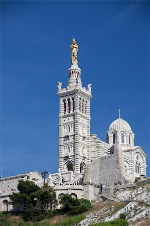 french riviera - Famous Notre-Dame-de-la-Garde on the hill in Marseille in France Foto de stock - Super Valor sin royalties y Suscripción, Código: 400-04876254