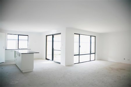 As above - black stone kitchen bench top, unfinished flooring, white wall. Stock Photo - Budget Royalty-Free & Subscription, Code: 400-04876734