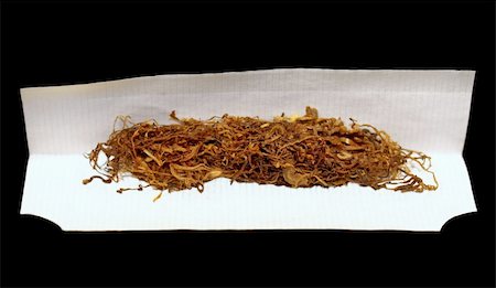 tobacco and rolling paper on black background Stock Photo - Budget Royalty-Free & Subscription, Code: 400-04878092