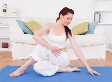 simsearch:400-04450996,k - Good looking red-haired female stretching in the living room in her appartment Stock Photo - Budget Royalty-Free & Subscription, Code: 400-04878849