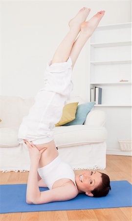 simsearch:400-04450996,k - Young good looking red-haired female stretching in the living room in her appartment Stock Photo - Budget Royalty-Free & Subscription, Code: 400-04878858