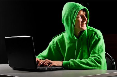 hacker. Young man with laptop is looking back Stock Photo - Budget Royalty-Free & Subscription, Code: 400-04879378