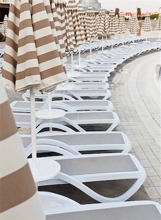 resort outdoor bed - Swimming pool area of hotel with umbrella and beach chair . Photographie de stock - Aubaine LD & Abonnement, Code: 400-04879854