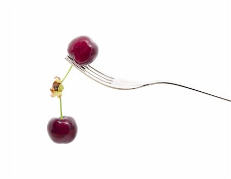 simsearch:400-06855989,k - a steel  fork with two cherries on white background Photographie de stock - Aubaine LD & Abonnement, Code: 400-04870020