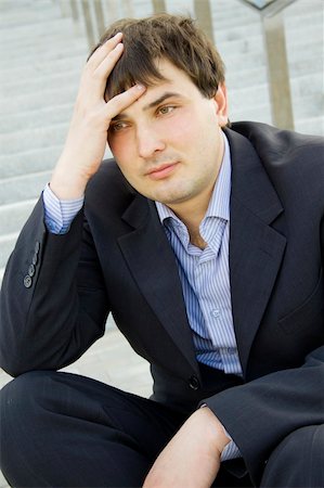 simsearch:400-08496169,k - Closeup of a young businessman sitting on thethe stairs of of the building . Dismissed, frustrated Stock Photo - Budget Royalty-Free & Subscription, Code: 400-04870032