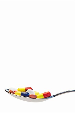 Spoon full of medicine on a white background Stock Photo - Budget Royalty-Free & Subscription, Code: 400-04870211