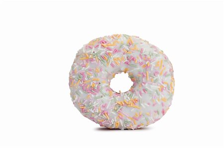 simsearch:400-06524508,k - Pink Iced Doughnut covered in sprinkles isolated against white background Stock Photo - Budget Royalty-Free & Subscription, Code: 400-04870221