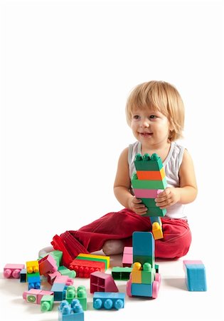 Smiling little boy playing with blocks, studio shot Stock Photo - Budget Royalty-Free & Subscription, Code: 400-04870351